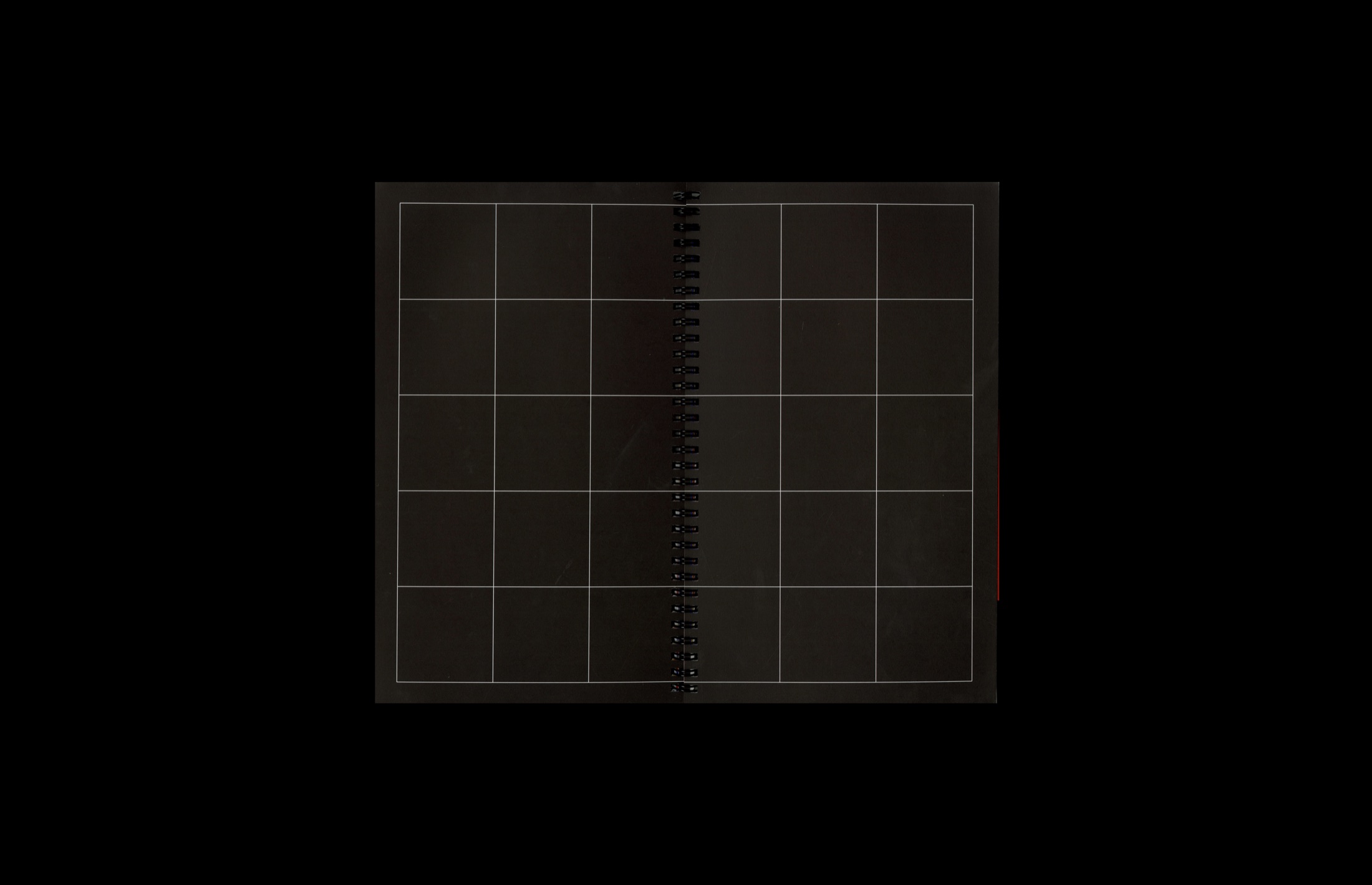 The publication fully unfolded into a dark gridded game board