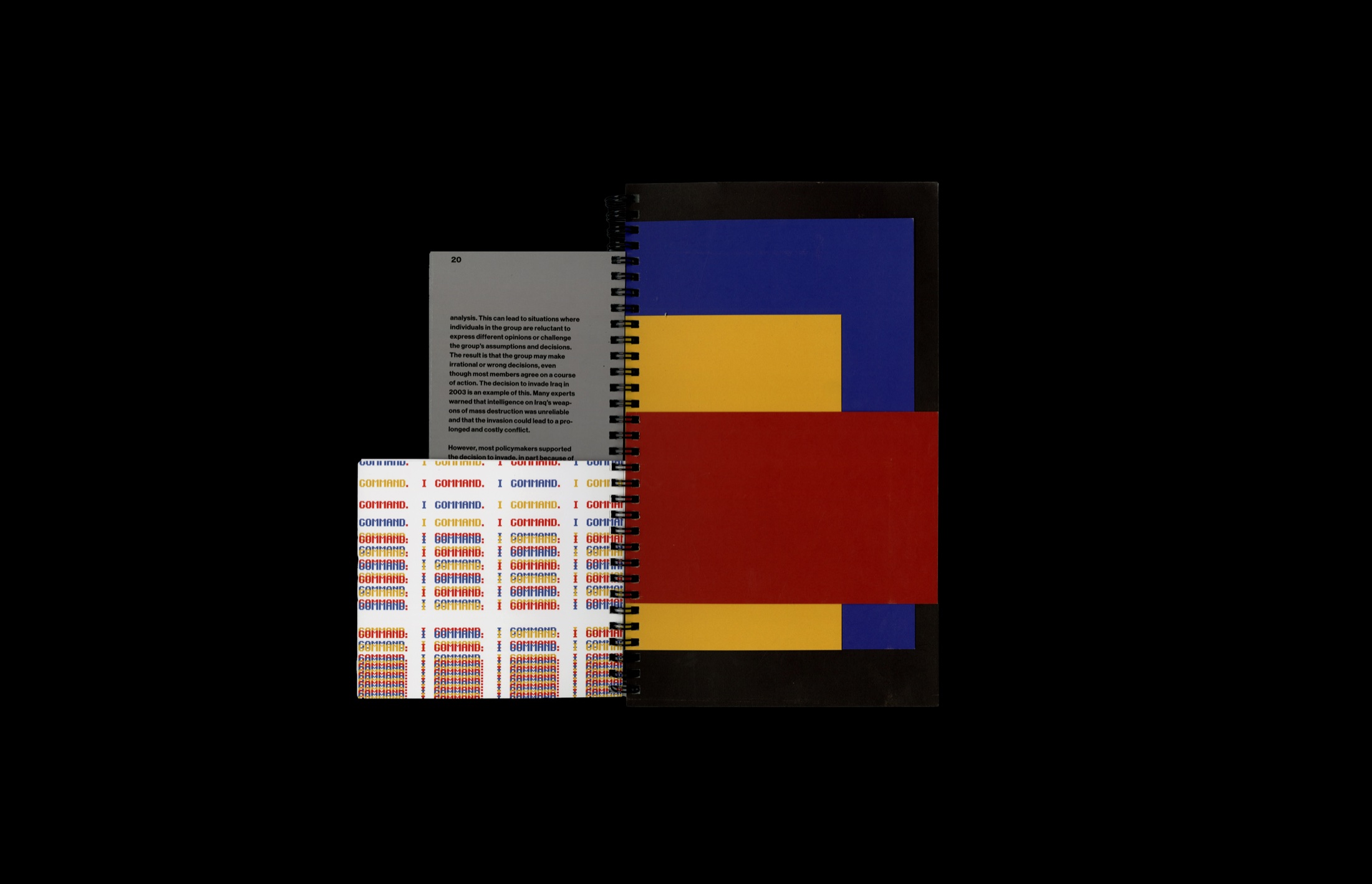 Colorful printed game sheet and book components on a black surface