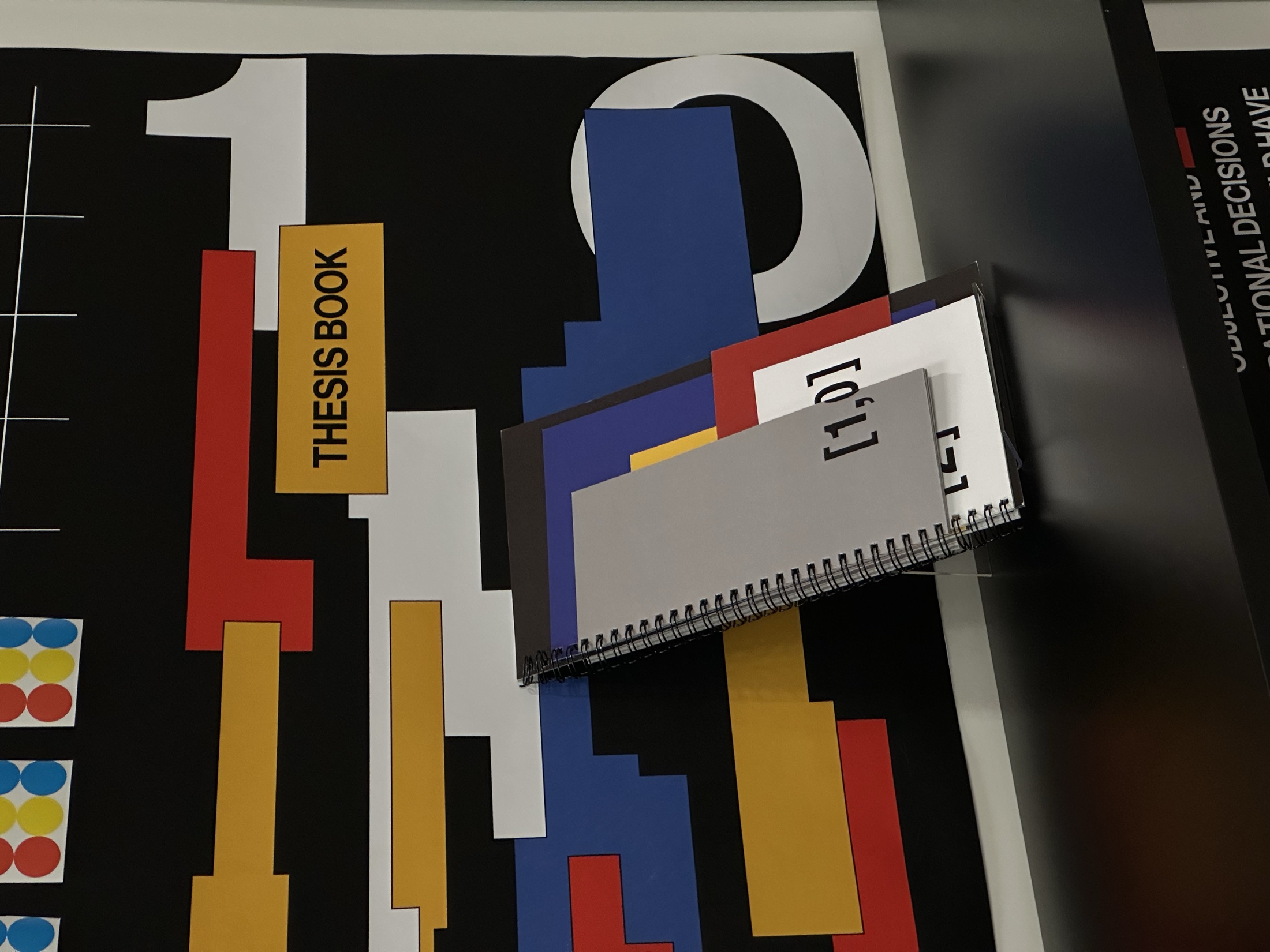 Detail of the [1,0,2,4] book displayed in front of the exhibition graphics