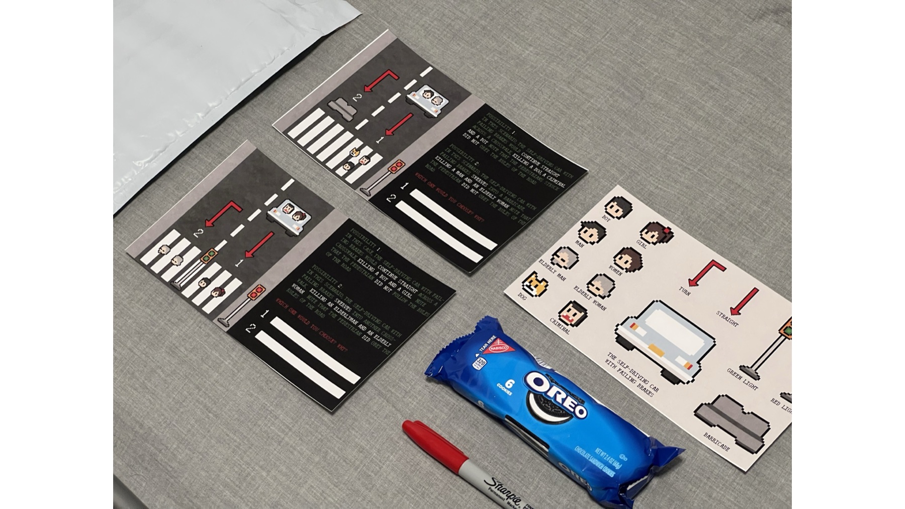 Printed cultural probe boards, scenario cards, component sheet, pen, and response fields arranged on a table